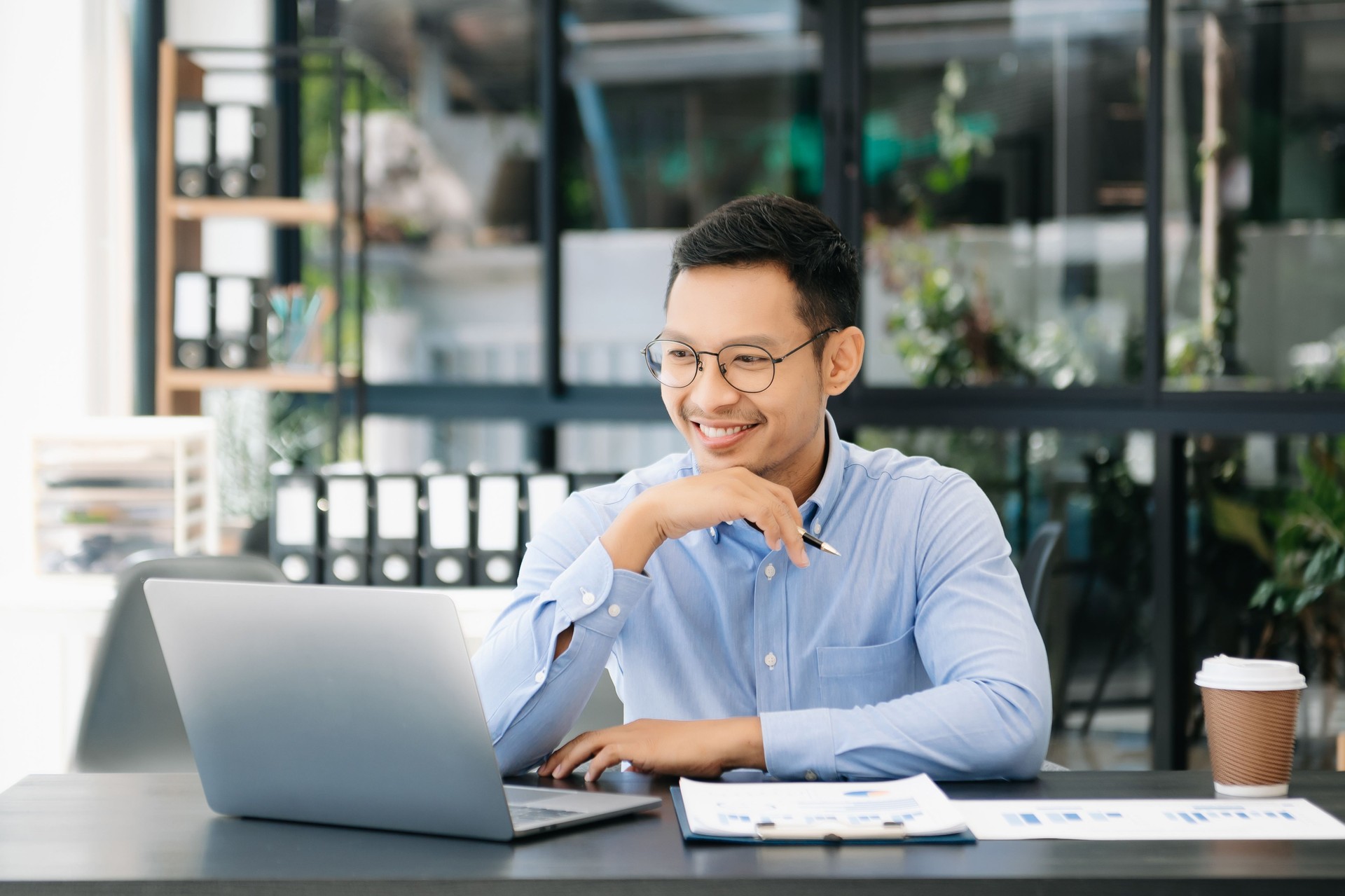 Mature business man executive manager looking at laptop watching online webinar training or having virtual meeting video conference